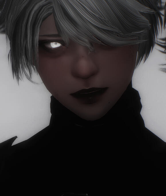 An up-close-and-personal picture of a white male with soft features, coyly glancing to the side. He has small pupils that stand out against his large, bright eyes. He has heavy makeup, sporting dark lipstick and big circles under his eyes masked with heavy